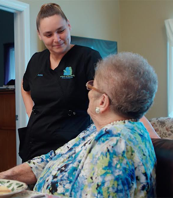In-Home Health Caregiver checking blood pressure of elder care patient.